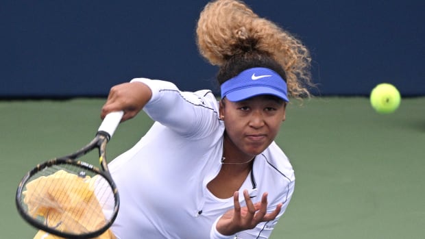 Naomi Osaka hits a serve.